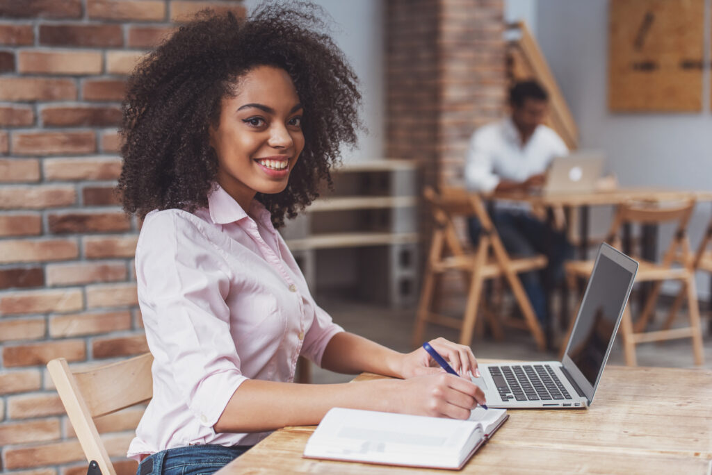 Vrouwelijke medewerker detacheringbureau met een laptop en notitieblok